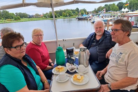 Mitglieder an Tischen auf dem Schiff