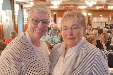 Birgit Becker und Jutta Da Corte stehen zusammen in einem Saal