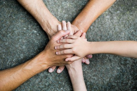 F&uuml;nf Personen legen jeweils eine Hand aufeinander, so dass ein Kreis bzw. ein Stern entsteht